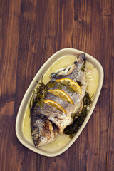 baked fish with lemon on dish