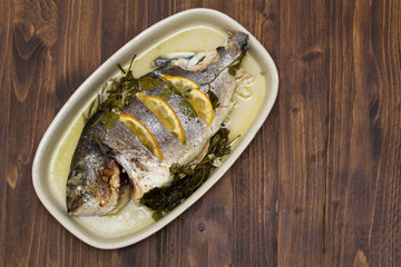 baked fish with lemon on dish