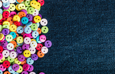 Multi colored buttons on a denim background