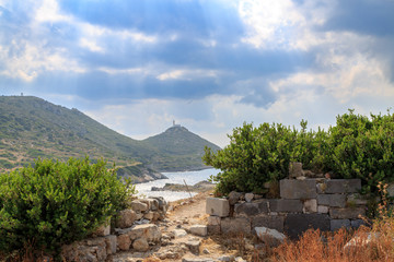 Lighthouse between ancient city remmants in Knidos, Datca, Turkey