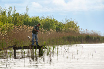 Fototapeta na wymiar Fishing as recreation and sports by fisherman.