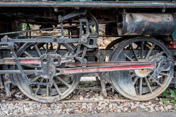 Fototapeta na wymiar Steam locomotive wheels and mechanics closeup
