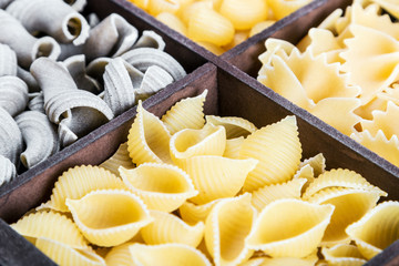 pasta assortment background. Pasta in a wooden box. Italian pasta of different colors