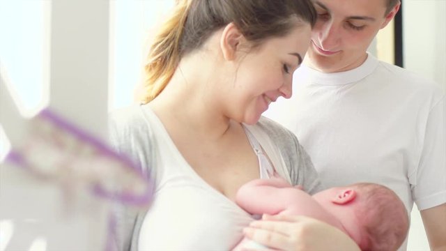 Happy young family. Father, mother and their newborn baby. Parenthood concept. 3840X2160 4K UHD video