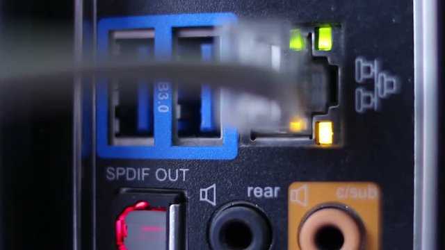 Network cable connection closeup plugging in, blinking LEDs