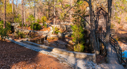 Panoramic view of the Grist Mill and creek flowing into the lake in the Stone Mountain Park in sunny autumn day, Georgia, USA