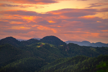 Beautiful dramatic sky sunset in the mountains with orange clouds. In Pang Ma Pha Meahongson Thailand.