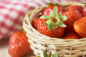 Organic fresh and ripe strawberries in woven basket