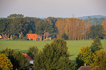 Naklejka premium High angle view of farmhouse in dutch rural summer landscape.