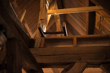 Old wooden ladder in the attic of church. - obrazy, fototapety, plakaty