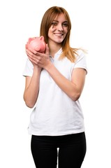 Happy Beautiful young girl holding a piggybank