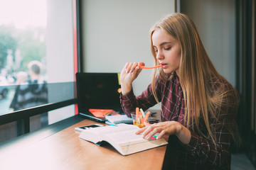 The student learns hard lessons or homework. Woman preparing for exams. Session at universities and institutes