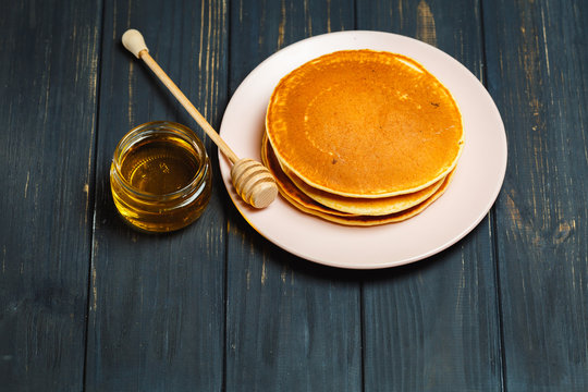 sweet Pancakes with honey in a jar