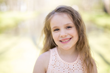 Portrait of a little girl on a yellow background. Girl seven years.