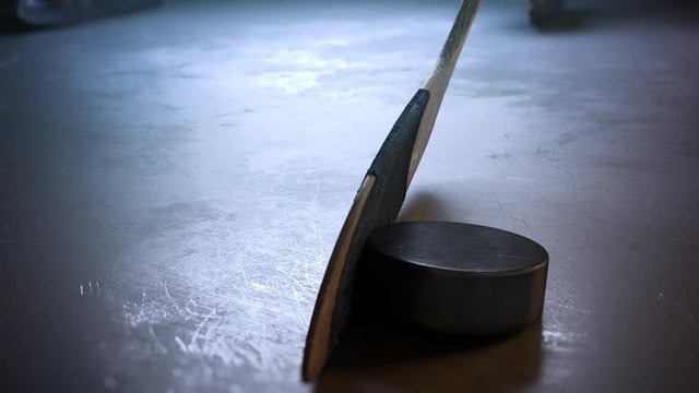 Close-up hockey stick hitting hockey puck in slow motion