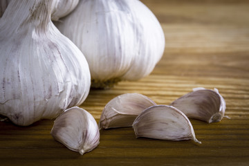 Garlics and bulbs on wooden table