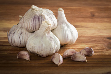 Garlics and bulbs on wooden table