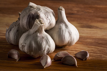 Garlics and bulbs on wooden table