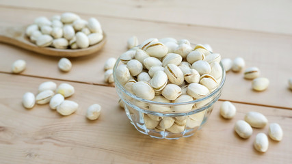 Pistachios on a wooden table.