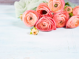 Beautiful pink ranunculus bouquet on turquoise background. Woman mother's day wedding. Holiday elegant bunch of flowers.