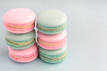 Stack of colorful mint and strawberry flavor macarons with copy space