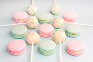Sweet pastel colors macarons and cake crumbs on sticks
