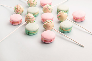 Sweet macarons and cake pops on sticks assortment