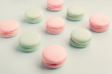 Colorful pink and green macaroons on blue background