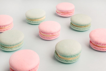 Fototapeta na wymiar Closeup of pink and mint colored macarons on blue background