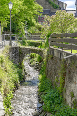 Medieval stone bridges lead across a brook in Bacharach to the Rhine river in Germany