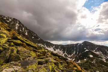 Alpine scenery in the spring, with storm clouds at sunset
