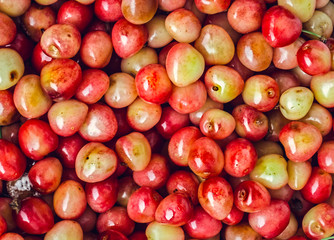 Fresh yellow cherries background, top view