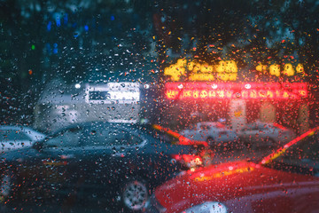 Wet with rain street through the glass of the car in China.