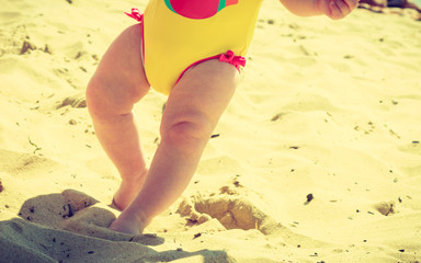 Baby feet walking on sand