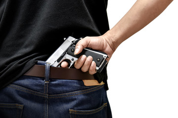 The man pulls out a gun tucked in his pant