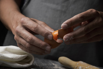 young man separating the yolk of an egg