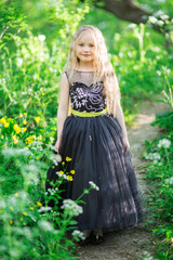 Beautiful child girl in yellow garden