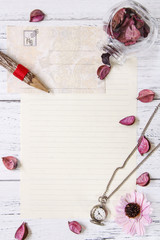 Flat lay stock photography purple flower petals letter envelope paper transparent glass bottle pocket clock wood pencil