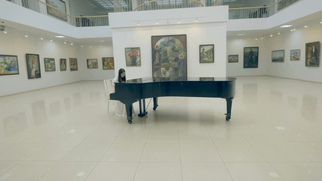 Musician playing the piano. Steadicam shot. 4K.