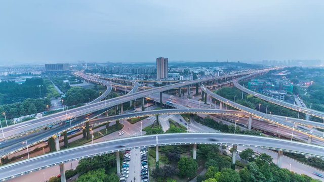 Time lapse of the busy interchange traffic in city from day to night