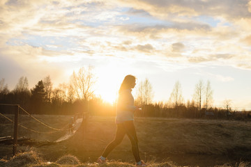 Girl walking on the sunset