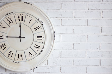 close up of vintage clock on brick wall
