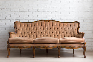 vintage sofa over white brick wall