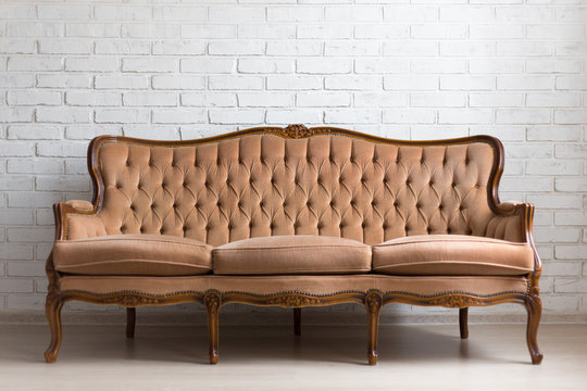 vintage sofa over white brick wall