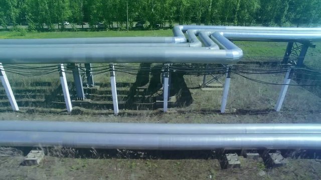 AERIAL Pipes with hot water. Heat carrier steel pipes from CHP, heat and power centers supply heat and water to the city. Front view.