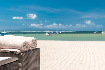 Cream beach towel on the ocean background. Tropical Bali island, Indonesia.