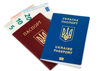 New ukrainian international biometric passport with chip and fingerprints lying on old ukrainian red international passport with 35 euro banknotes cash inside - visa fee, isolated on white. Top view