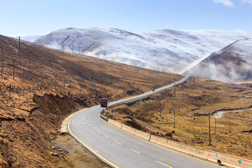 Truck on the road, Beautiful winter road in Tibet under snow mountain Sichuan China © Southtownboy Studio