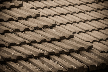 Earthenware roof of a building with leaves falling on it. Selective focus. Sepia tone. Vignetting...