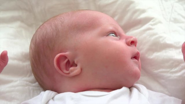 Cute newborn baby lying in his bed closeup. 4K UHD video 3840X2160